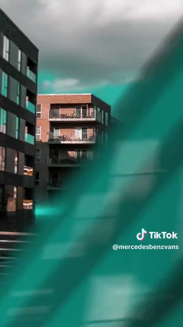 Red brick architecture seen through turquoise motion blur.